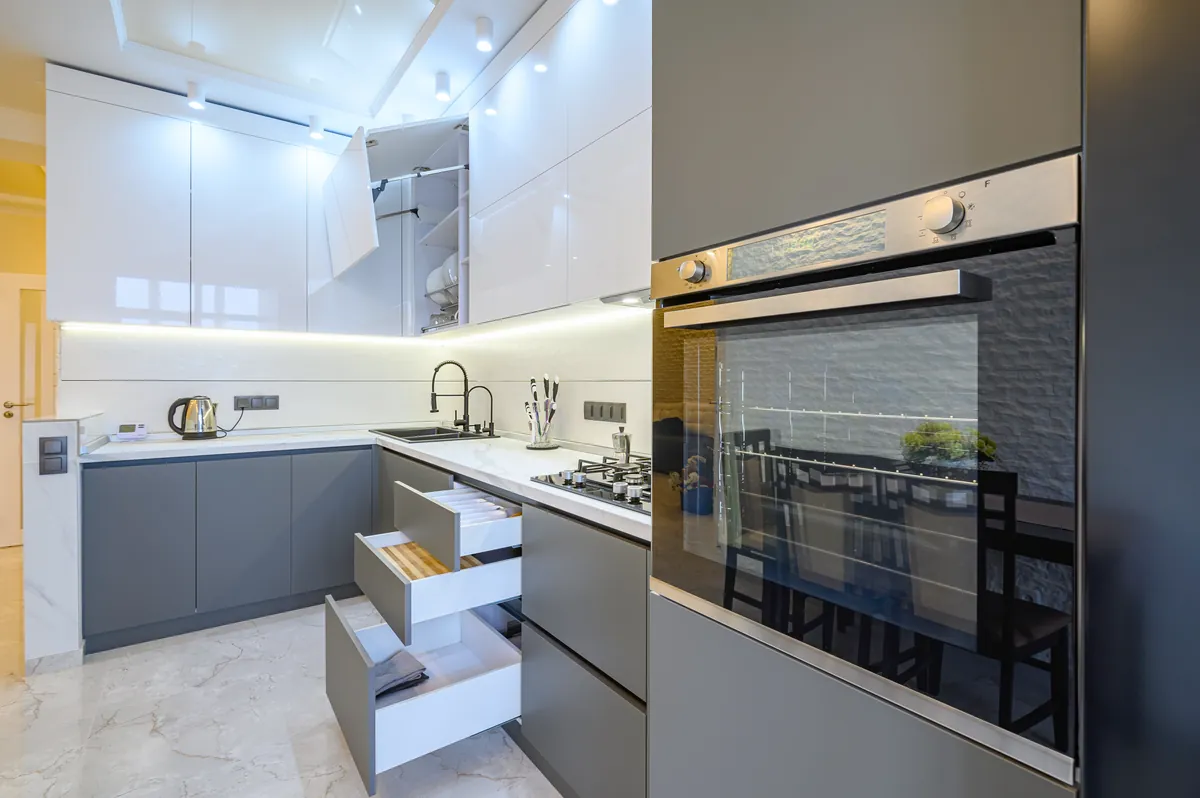 Kitchen with cabinet doors and drawers open, showing the finish carried through to the edges.