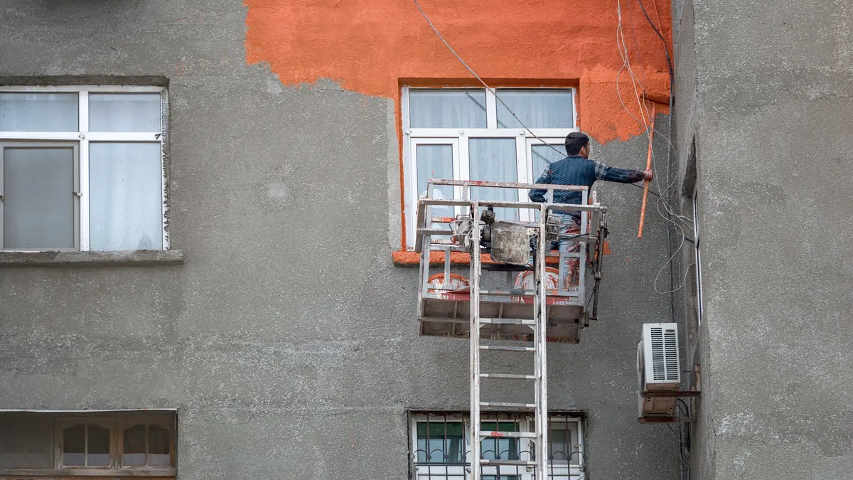 Commercial exterior being painted from scaffolding, working a full elevation.