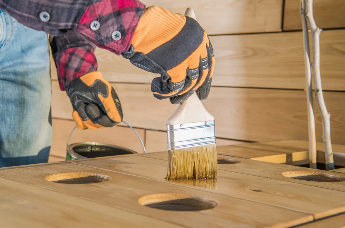 Protective coating brushed onto exterior timber to take the weather.