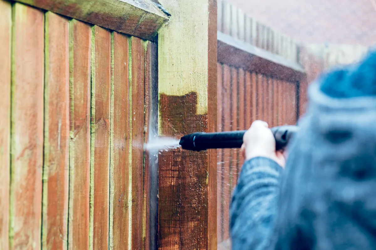 Timber fence washed down before any stain or paint is applied.