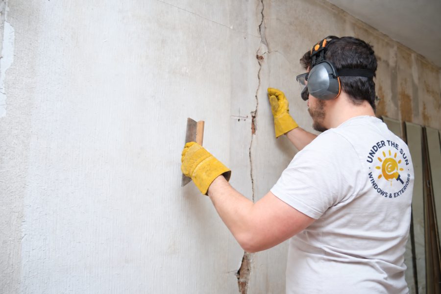 Drywall repair patch being textured to match the surrounding wall